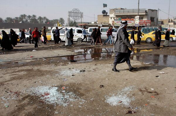 Broken glass remains at the scene of a suicide bomb attack at Adan Square in Baghdad. - Sputnik International