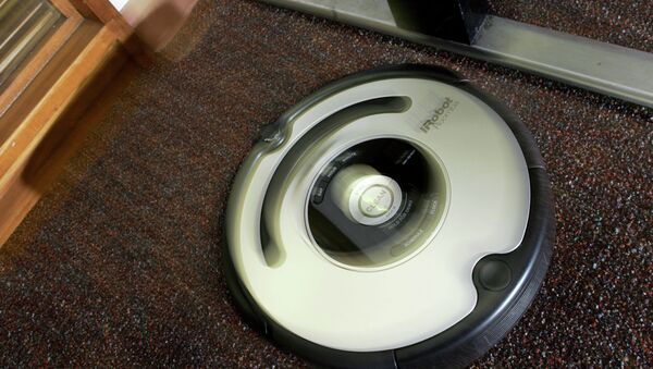 The Roomba vacuum cleaner by iRobot Corp. moves to clean an office carpet in Boston on Tuesday, Aug. 21, 2007. Nearly five years after rolling onto the market, the Roomba vacuum cleaner has undergone a ground-up redesign that has endowed the otherwise-brainy robot with the smarts to overcome rug tassels and electrical cords.  - Sputnik International