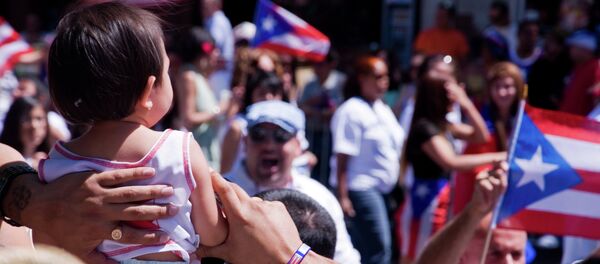 A kid takes in Las Fiestas Puertorriqueñas along Division Street in Humboldt Park. A kid takes in Las Fiestas Puertorriqueñas along Division Street in Humboldt Park. - Sputnik International