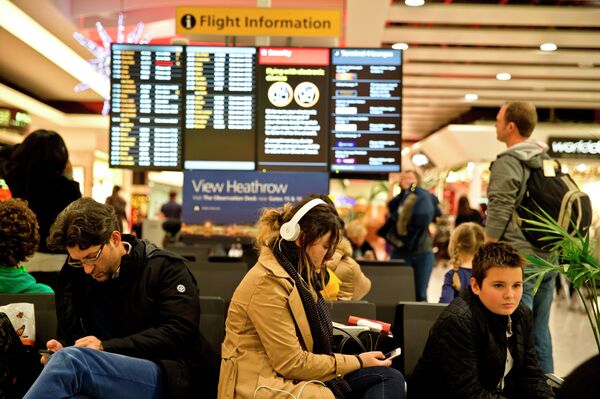 Passengers wait at Heathrow Airport in London. Passengers wait at Heathrow Airport in London. - Sputnik International