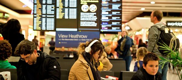 Passengers wait at Heathrow Airport in London, Friday, Dec. 12, 2014. Passengers wait at Heathrow Airport in London, Friday, Dec. 12, 2014. - Sputnik International