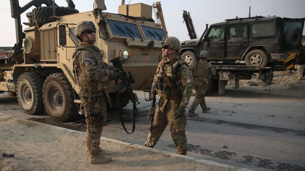 U.S. and British soldiers chat at the site of a suicide attack in Kabul, Afghanistan in January. - Sputnik International