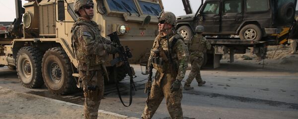U.S. and British soldiers chat at the site of a suicide attack in Kabul, Afghanistan in January. - Sputnik International