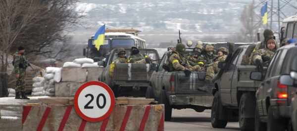 Ukrainian government troops sit in the back of pick-up trucks as they pass a checkpoint near the town of Mariupol, Ukraine Ukrainian government troops sit in the back of pick-up trucks as they pass a checkpoint near the town of Mariupol, Ukraine - Sputnik International