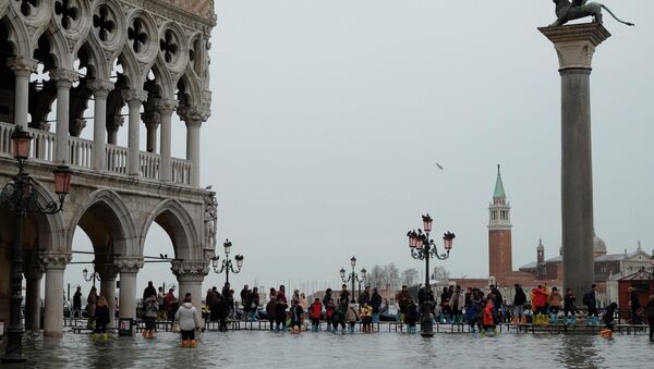 Venice, Italy: People walk on the Catwalk in a flooded St. Mark's Square during a period of seasonal high water in Venice. - Sputnik International