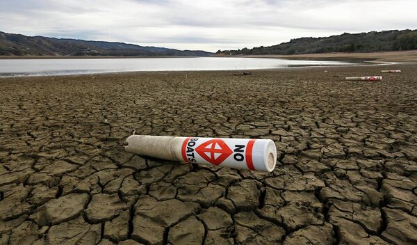 In this Feb. 4 2014 file photo, a warning buoy sits on the dry, cracked bed of Lake Mendocino near Ukiah, Calif. As bad as the drought in California and the Southwest was last year and in the Midwest a couple years ago, scientists say far worse historic decades-long dry spells are coming. “ In this Feb. 4 2014 file photo, a warning buoy sits on the dry, cracked bed of Lake Mendocino near Ukiah, Calif. As bad as the drought in California and the Southwest was last year and in the Midwest a couple years ago, scientists say far worse historic decades-long dry spells are coming. “ - Sputnik International