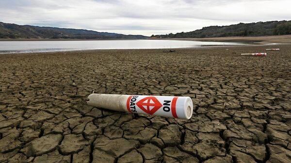 In this Feb. 4 2014 file photo, a warning buoy sits on the dry, cracked bed of Lake Mendocino near Ukiah, Calif. As bad as the drought in California and the Southwest was last year and in the Midwest a couple years ago, scientists say far worse historic decades-long dry spells are coming. “ - Sputnik International