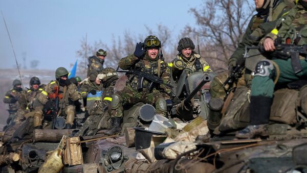 Members of the Ukrainian armed forces ride on armoured personnel carriers (APC) near Debaltseve, eastern Ukraine, February 12, 2015 - Sputnik International
