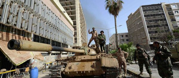 Members of the Libyan pro-government forces, backed by locals, gather on a tank outside the Central Bank, near Benghazi port, January 21, 2015 Members of the Libyan pro-government forces, backed by locals, gather on a tank outside the Central Bank, near Benghazi port, January 21, 2015 - Sputnik International