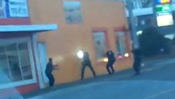 In this still frame taken from a cell phone video provided by Dario Infante and taken on Feb. 10, 2015, Antonio Zambrano-Montes, left, turns to face police officers as one holds a flashlight and two others draw their guns just before shooting him in Pasco, Wash. - Sputnik International