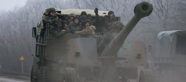 Members of the Ukrainian armed forces ride on a military vehicle near Artemivsk, eastern Ukraine February 14, 2015 - Sputnik International