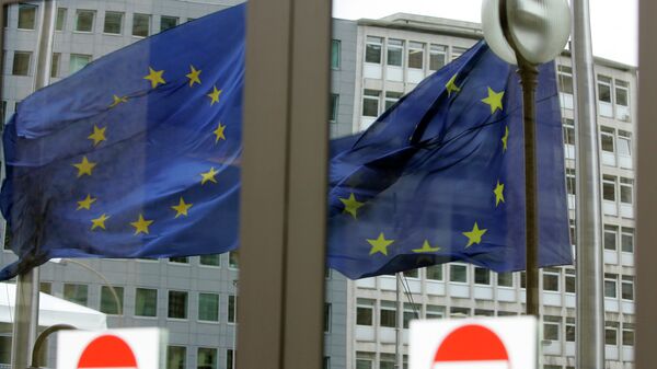 The EU nations flags are mirrored in the windows of the EU Council headquarters ahead of a two-day EU summit in Brussels, Wednesday March 12, 2008 - Sputnik International