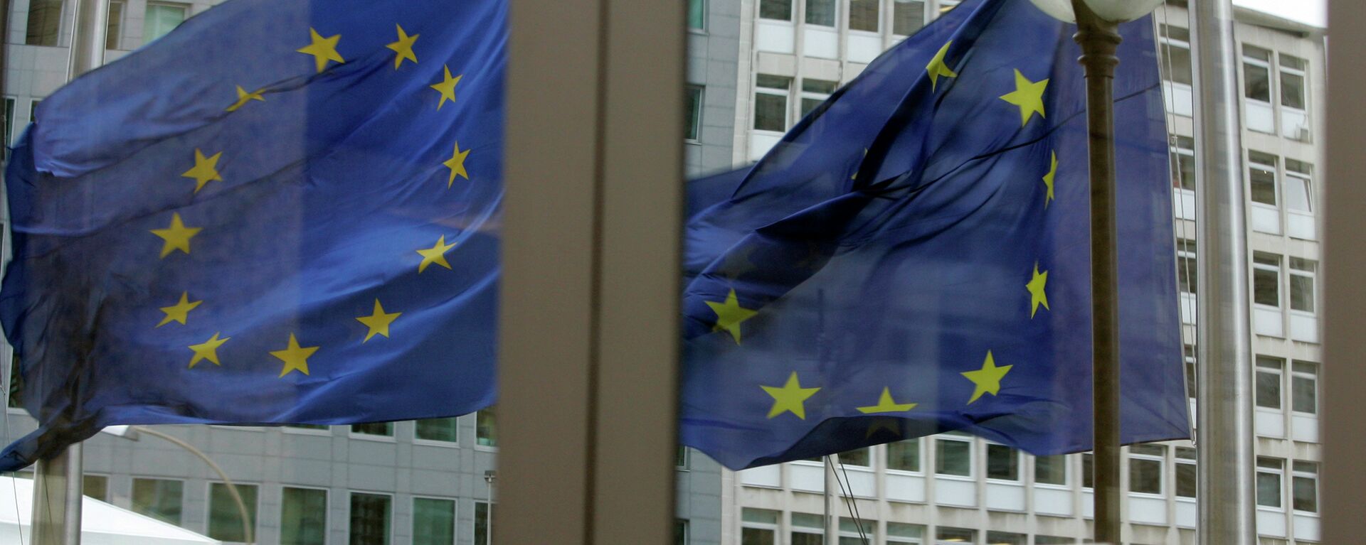 The EU nations flags are mirrored in the windows of the EU Council headquarters ahead of a two-day EU summit in Brussels, Wednesday March 12, 2008 - Sputnik International, 1920, 23.06.2023
