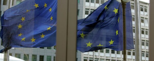 The EU blacklist targets a total of 19 individuals from Ukraine and Russia. Above: The EU nations flags are mirrored in the windows of the EU Council headquarters. The EU blacklist targets a total of 19 individuals from Ukraine and Russia. Above: The EU nations flags are mirrored in the windows of the EU Council headquarters. - Sputnik International