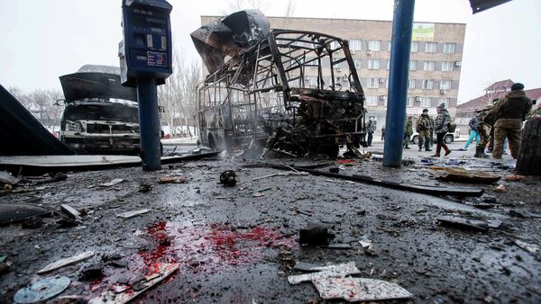 Destroyed vehicles, debris and blood on the ground are seen at a bus station after shelling in Donetsk, February 11, 2015 - Sputnik International
