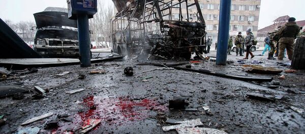 Destroyed vehicles, debris and blood on the ground are seen at a bus station after shelling in Donetsk, February 11, 2015 Destroyed vehicles, debris and blood on the ground are seen at a bus station after shelling in Donetsk, February 11, 2015 - Sputnik International