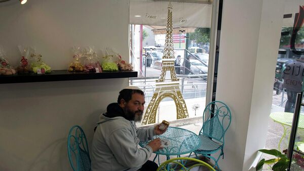 A member of the French community sits in a patisserie in Netanya, a city of 180,000 on the Mediterranean north of Tel Aviv, that has become the semi-official capital of the French community in Israel January 25, 2015 - Sputnik International