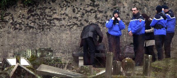 Police officers investigate the site of defaced tombstones at the Jewish cemetery of Sarre-Union, eastern France, Monday, Feb. 16, 2015 Police officers investigate the site of defaced tombstones at the Jewish cemetery of Sarre-Union, eastern France, Monday, Feb. 16, 2015 - Sputnik International
