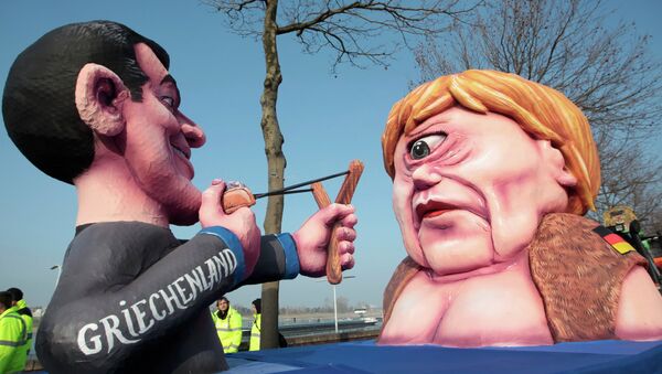 A carnival float with papier-mache caricatures of German Chancellor Angela Merkel (R) and a figure representing Greece (L) takes part in the traditional Rose Monday carnival parade in the western German city of Duesseldorf February 16, 2015 - Sputnik International