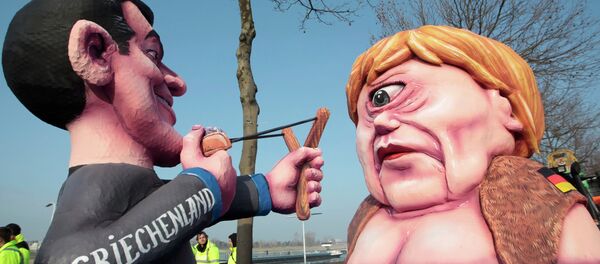 A carnival float with papier-mache caricatures of German Chancellor Angela Merkel (R) and a figure representing Greece (L) takes part in the traditional Rose Monday carnival parade in the western German city of Duesseldorf February 16, 2015 A carnival float with papier-mache caricatures of German Chancellor Angela Merkel (R) and a figure representing Greece (L) takes part in the traditional Rose Monday carnival parade in the western German city of Duesseldorf February 16, 2015 - Sputnik International