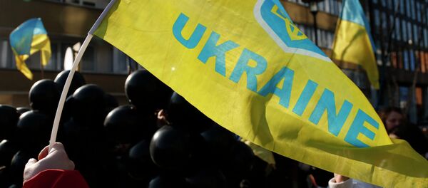 Demonstrator waves a Ukrainian flag Demonstrator waves a Ukrainian flag - Sputnik International