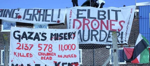 Protestors from various groups climbed over security fencing and onto the roof of the Instro Precision building in Kent. Protestors from various groups climbed over security fencing and onto the roof of the Instro Precision building in Kent. - Sputnik International
