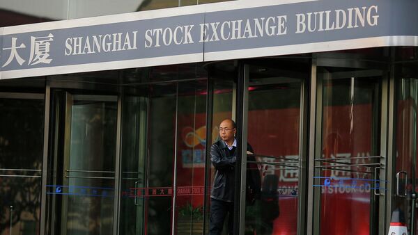 A man walks out of the Shanghai Stock Exchange building at the Pudong financial district in Shanghai - Sputnik International