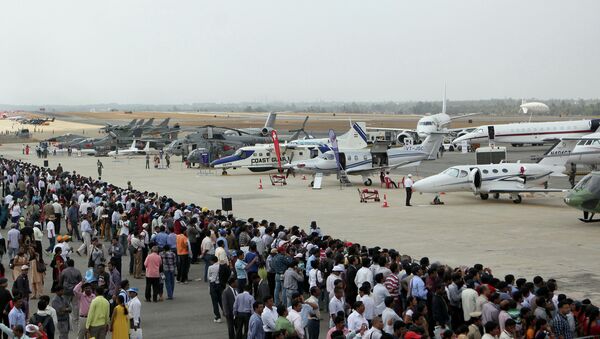 Visitors look at aircraft parked at the static display area on the third day of Aero India 2013 at Yelahanka Air Force station in Bangalore on February 8, 2013. File photo - Sputnik International