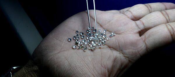 In this photograph taken on December 5, 2014, an Indian supervisor looks at the finished diamonds on a production line at a processing centre in Surat, some 265kms. south of Ahmedabad In this photograph taken on December 5, 2014, an Indian supervisor looks at the finished diamonds on a production line at a processing centre in Surat, some 265kms. south of Ahmedabad - Sputnik International