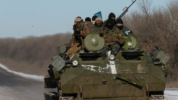 Members of the Ukrainian armed forces ride on a military vehicle near Debaltseve, eastern Ukraine, February 17, 2015 - Sputnik International