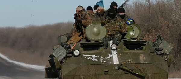 Members of the Ukrainian armed forces ride on a military vehicle near Debaltseve, eastern Ukraine, February 17, 2015 Members of the Ukrainian armed forces ride on a military vehicle near Debaltseve, eastern Ukraine, February 17, 2015 - Sputnik International