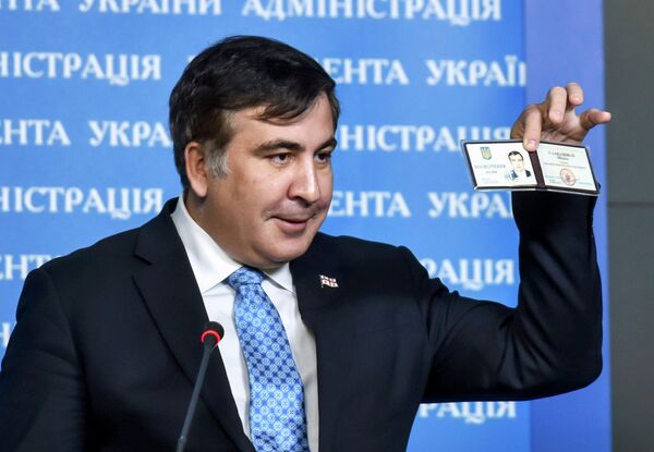 Former Georgia's President Mikheil Saakashvili shows off his identification card as the head of an advisory council in Kiev, in this February 17, 2015 handout photo supplied by the Ukrainian Presidential Press Service Former Georgia's President Mikheil Saakashvili shows off his identification card as the head of an advisory council in Kiev, in this February 17, 2015 handout photo supplied by the Ukrainian Presidential Press Service - Sputnik International