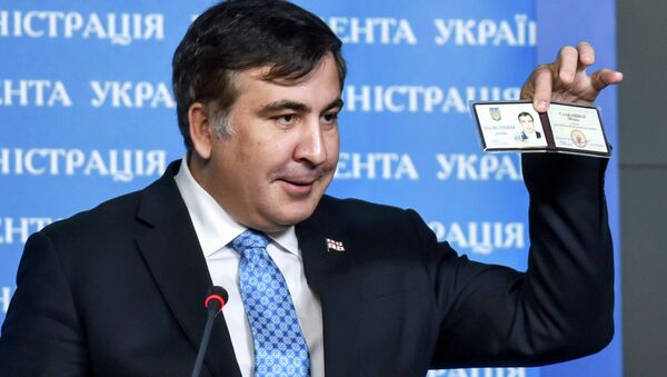 Former Georgia's President Mikheil Saakashvili shows off his identification card as the head of an advisory council in Kiev, in this February 17, 2015 handout photo supplied by the Ukrainian Presidential Press Service - Sputnik International