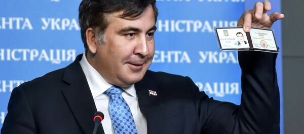 Former Georgia's President Mikheil Saakashvili shows off his identification card as the head of an advisory council in Kiev, in this February 17, 2015 handout photo supplied by the Ukrainian Presidential Press Service - Sputnik International