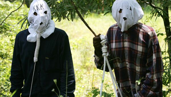 Ben Reed, right, and Keith Christian, left, portraying Klansmen, run through a reenactment of the 1946 lynching at the Moore's Ford Bridge, to raise awareness for the unsolved murders. - Sputnik International