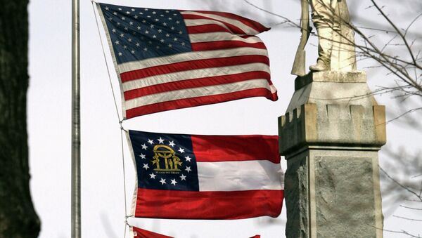 A U.S. flag, a Georgia flag and a Walton County flag flank a monument To Our Confederate Dead on the Walton County, Ga., courthouse lawn in Monroe, Ga. - Sputnik International