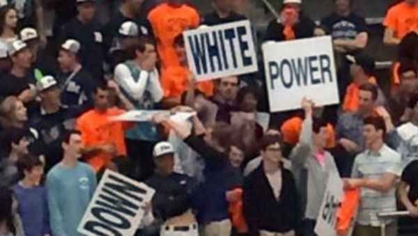 Fans of the Home team hold up White Power signs. - Sputnik International