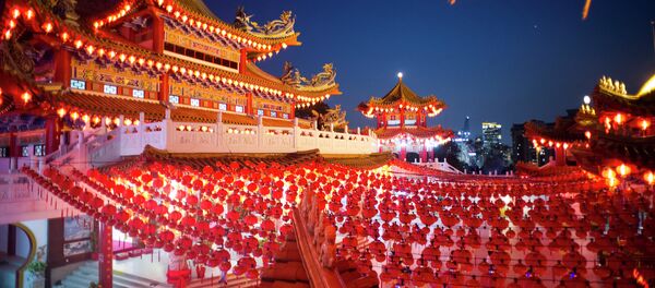 Visitors walks underneath traditional Chinese lantern decorations at a temple ahead of the Chinese Lunar New Year in Kuala Lumpur, Malaysia - Sputnik International