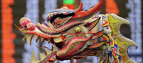 A performer raises a dragon head as part of a dance performance at the Philippine stock exchange for Lunar New Year of the Sheep celebrations in Manila A performer raises a dragon head as part of a dance performance at the Philippine stock exchange for Lunar New Year of the Sheep celebrations in Manila - Sputnik International