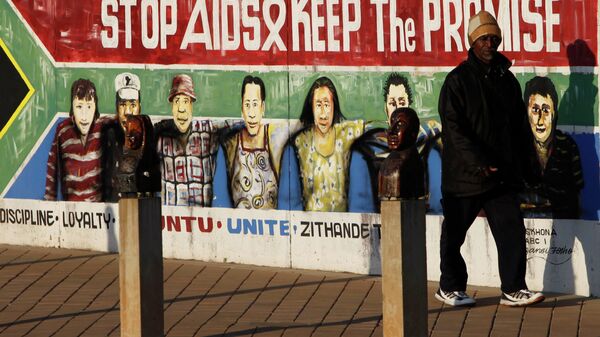 A pedestrian passes an AIDS education billboard in Johannesburg, South Africa. - Sputnik International