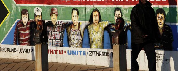 A pedestrian passes an AIDS education billboard in Johannesburg, South Africa. - Sputnik International