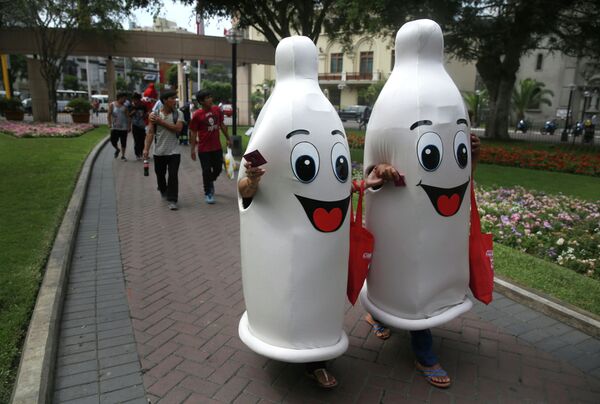 Two women dressed as condoms walk during an awareness program on International Condom Day in Lima, Peru. Two women dressed as condoms walk during an awareness program on International Condom Day in Lima, Peru. - Sputnik International
