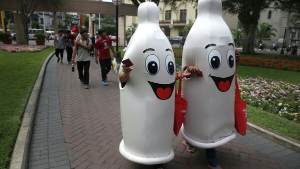 Two women dressed as condoms walk during an awareness program on International Condom Day in Lima, Peru. - Sputnik International