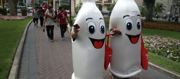 Two women dressed as condoms walk during an awareness program on International Condom Day in Lima, Peru. - Sputnik International