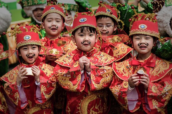 Children wearing traditional costumes pose during preparations for Chinese lunar new year celebrations in Hong Kong - Sputnik International