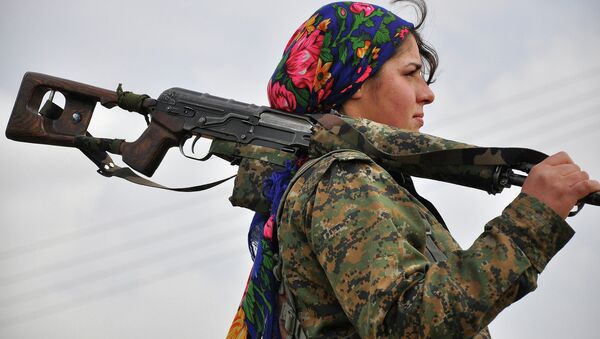 A Kurdish female fighter of the Women's Protection Units (YPJ) looks on at a training camp in al-Qahtaniyah, near the Syrian-Turkish border - Sputnik International