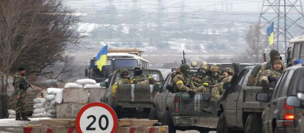 Ukrainian government troops sit in the back of pick-up trucks as they pass a checkpoint near the town of Mariupol, Ukraine Ukrainian government troops sit in the back of pick-up trucks as they pass a checkpoint near the town of Mariupol, Ukraine - Sputnik International