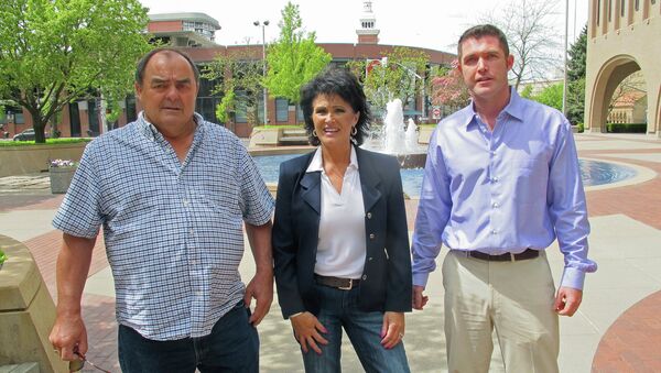 Larry Harvey, Rhonda Firestack-Harvey, and Rolland Gregg stand in the plaza in front of the federal courthouse in Spokane, Wash. The three are charged with growing marijuana at a remote farm near Kettle Falls, Wash. - Sputnik International