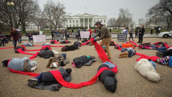 Anti-abortion activists are connected with a red piece of cloth as they stage a die-in in front of the White House. - Sputnik International