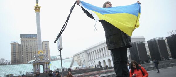 A participant marking the anniversary of the events on Kiev's Independence Square A participant marking the anniversary of the events on Kiev's Independence Square - Sputnik International